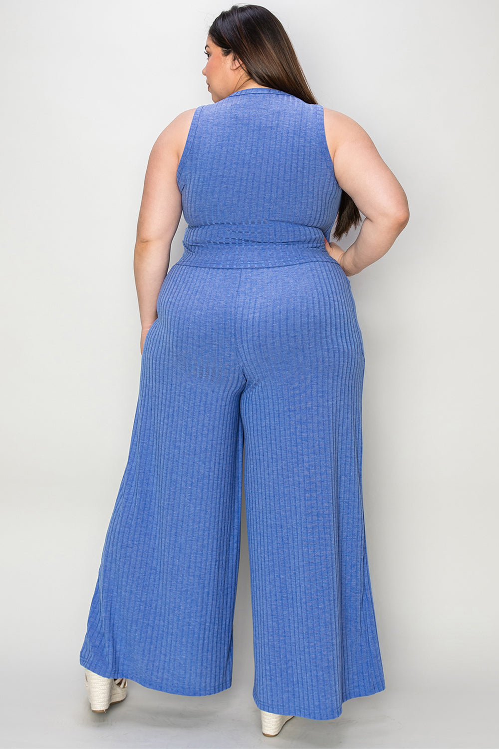 Back view of plus-size blue ribbed tank and wide-leg pants set with frill details, featuring a moderate stretch fabric.