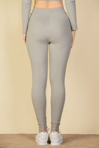 Back view of ribbed tie front leggings in grey, featuring a soft stretch rib knit fabric. Model is 5'9" wearing size S.