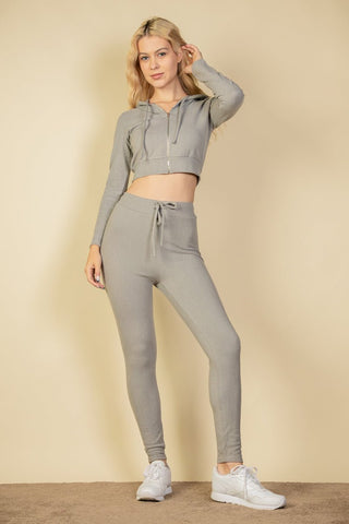 Ribbed tie front leggings in gray, featuring elastic drawstring band and soft brushed fabric, paired with a matching crop top.