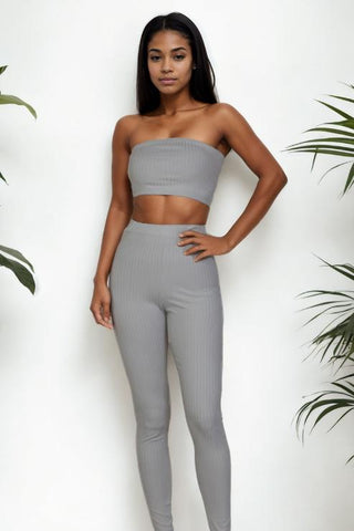 Model wearing grey ribbed tube top and leggings set, made of polyester and spandex blend for a bodycon fit.