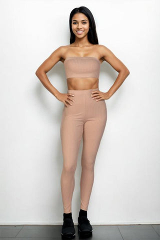 Model wearing a ribbed tube top and leggings set, featuring bodycon fit in polyester and spandex, showcasing style and comfort.