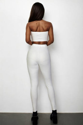 Back view of white ribbed tube top and leggings set, showcasing a bodycon fit made from polyester and spandex blend.