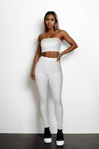 Woman wearing a white ribbed tube top and leggings set made of 92% polyester and 8% spandex, showcasing bodycon style.