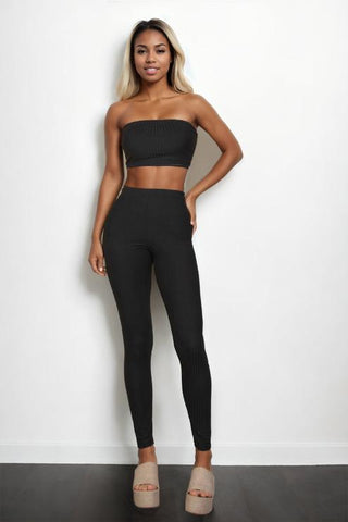 Model wearing black ribbed tube top and leggings set, bodycon fit, made from 92% polyester and 8% spandex for a stylish look.