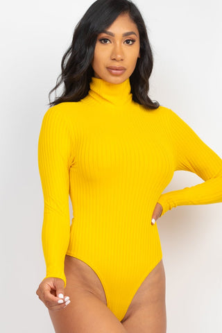 Yellow ribbed turtle neck long sleeve bodysuit with high stretch and soft knit fabric, showcasing elegant design on a model.