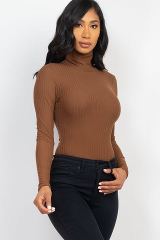 Model wearing brown ribbed turtle neck long sleeve bodysuit with high stretch fabric, paired with black jeans.