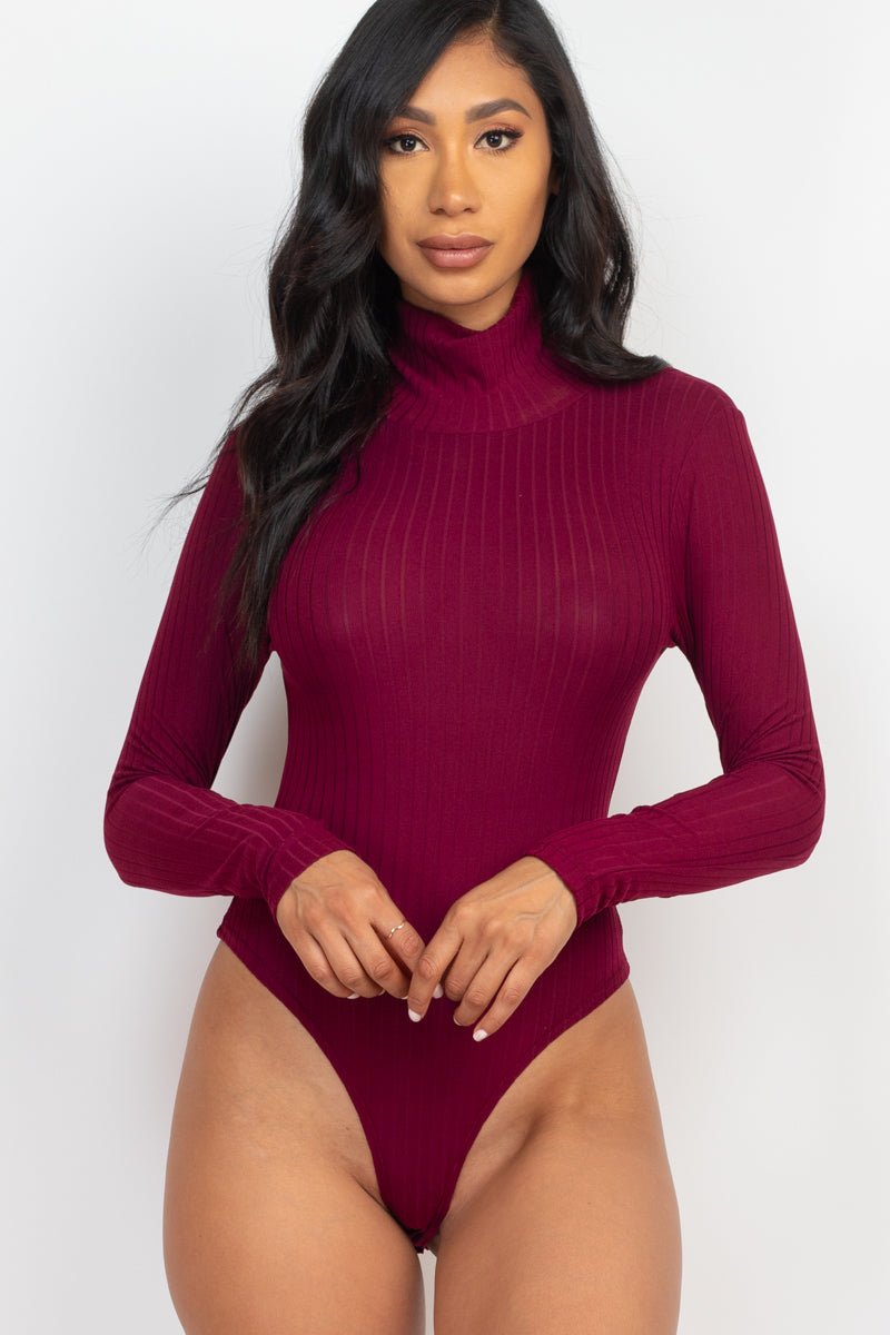 Model wearing a burgundy ribbed turtle neck long sleeve bodysuit, showcasing the high stretch and soft texture of the fabric.
