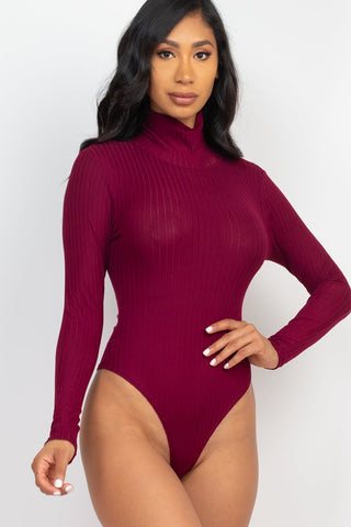 Model wearing maroon ribbed turtle neck long sleeve bodysuit, showcasing soft, lightweight fabric and slim fit design.