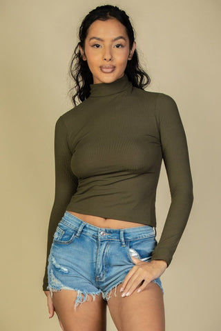 Model wearing ribbed turtleneck long sleeve top in olive, paired with denim shorts; soft, lightweight high-stretch material.