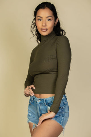 Woman wearing ribbed turtleneck long sleeve top and denim shorts, showcasing casual style. Soft, lightweight, and stretchy fabric.