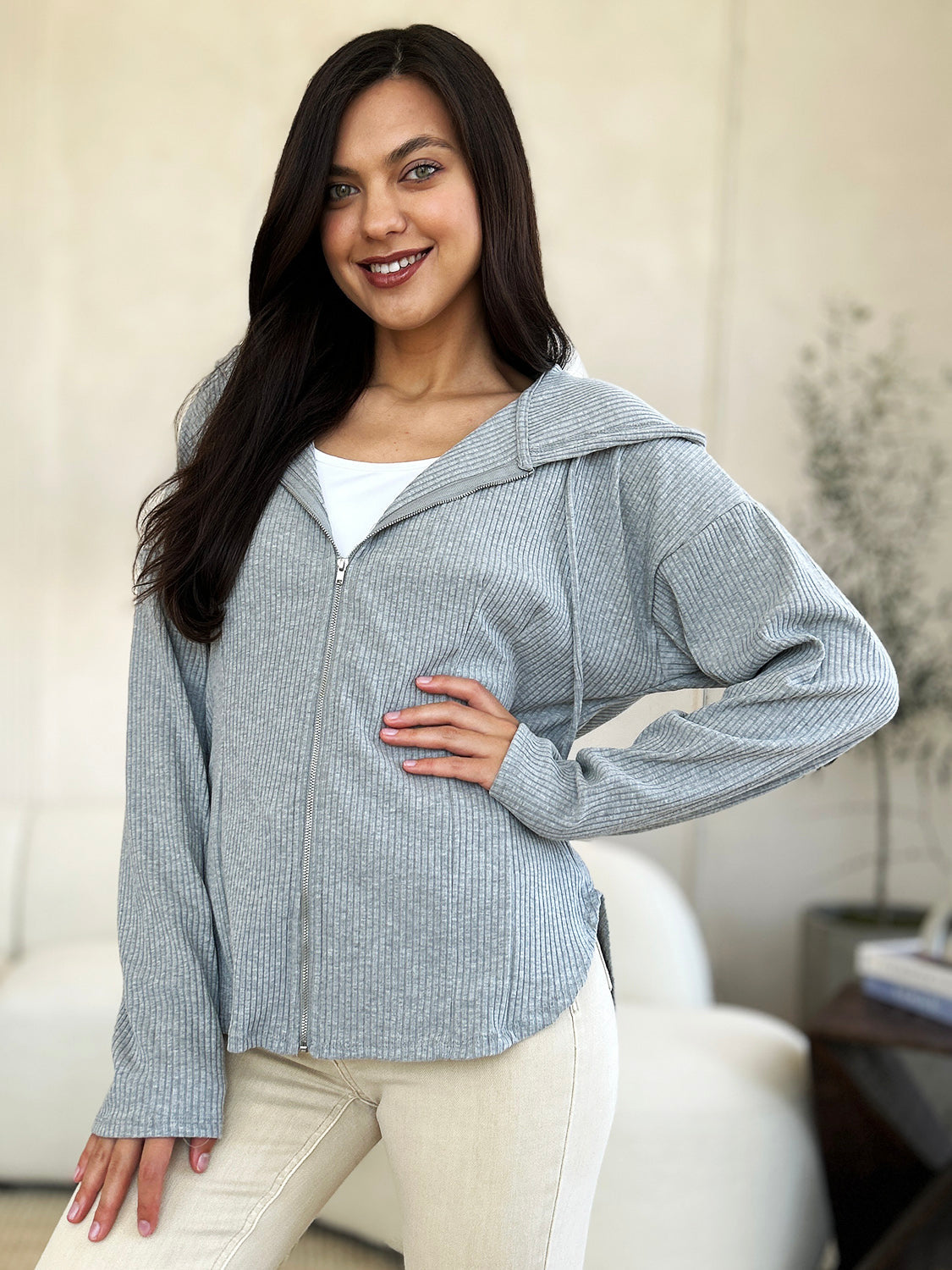 Woman wearing full-size ribbed zip-up drawstring hooded jacket in gray, casual and stylish outfit.