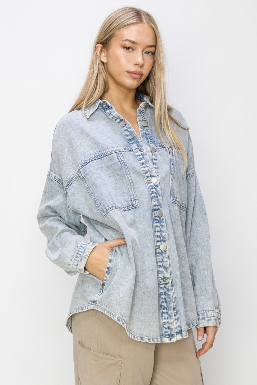 Woman wearing Risen Button Up Long Sleeve Shacket in light denim for casual style