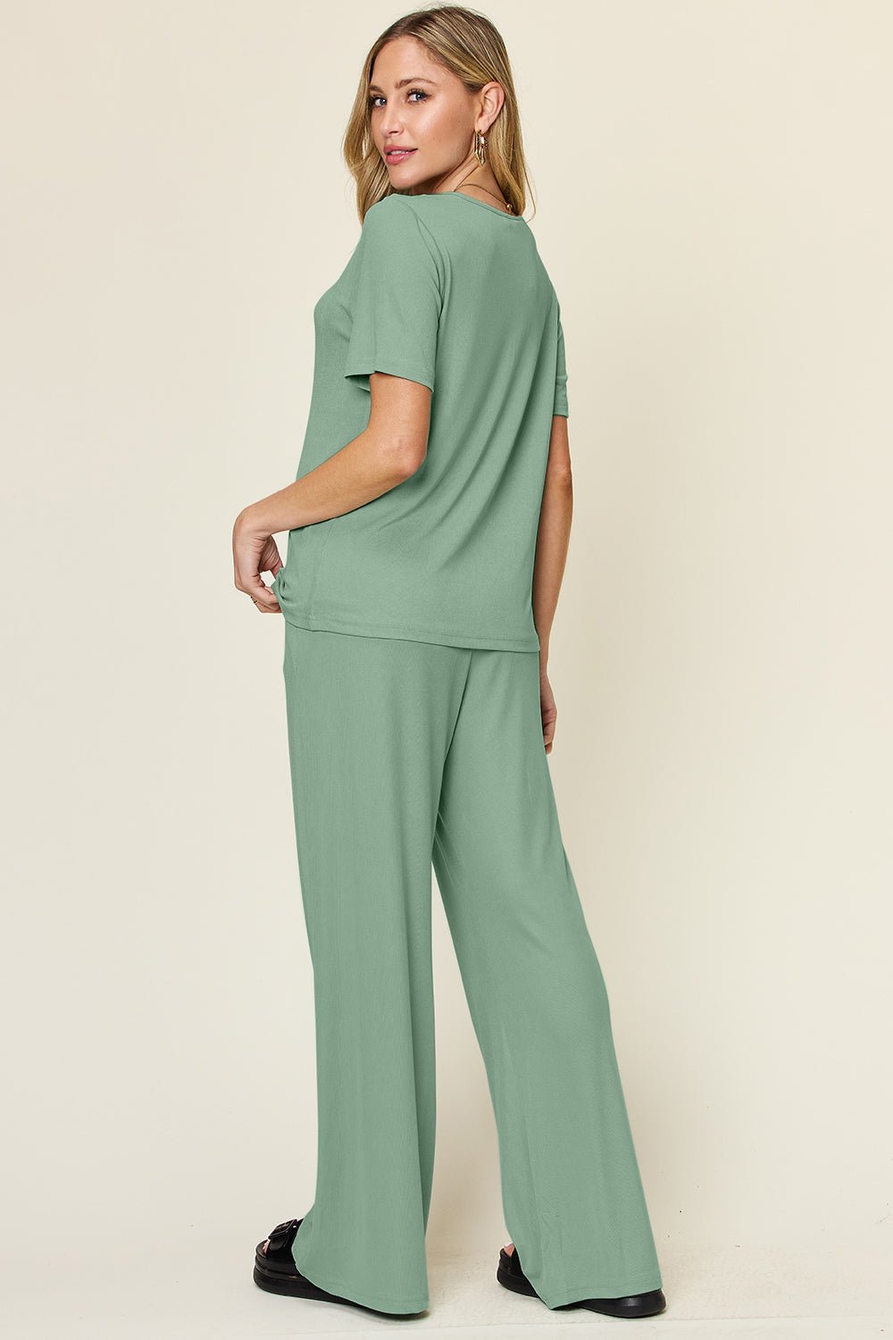 Woman wearing green round neck short sleeve t-shirt and wide leg pants set, basic style, slightly stretchy, two-piece outfit.