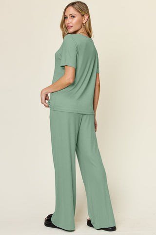 Woman wearing green round neck short sleeve t-shirt and wide leg pants set, basic style, slightly stretchy, two-piece outfit.