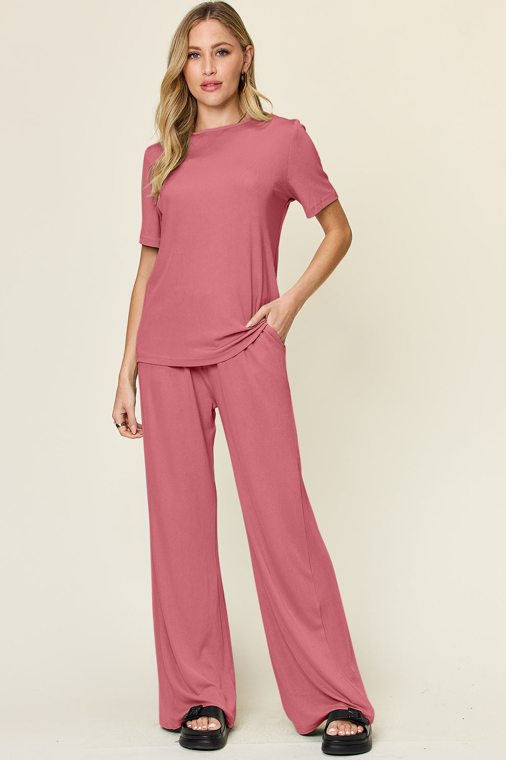 Woman wearing round neck short sleeve T-shirt and wide leg pants set in pink, basic style, slightly stretchy fabric.