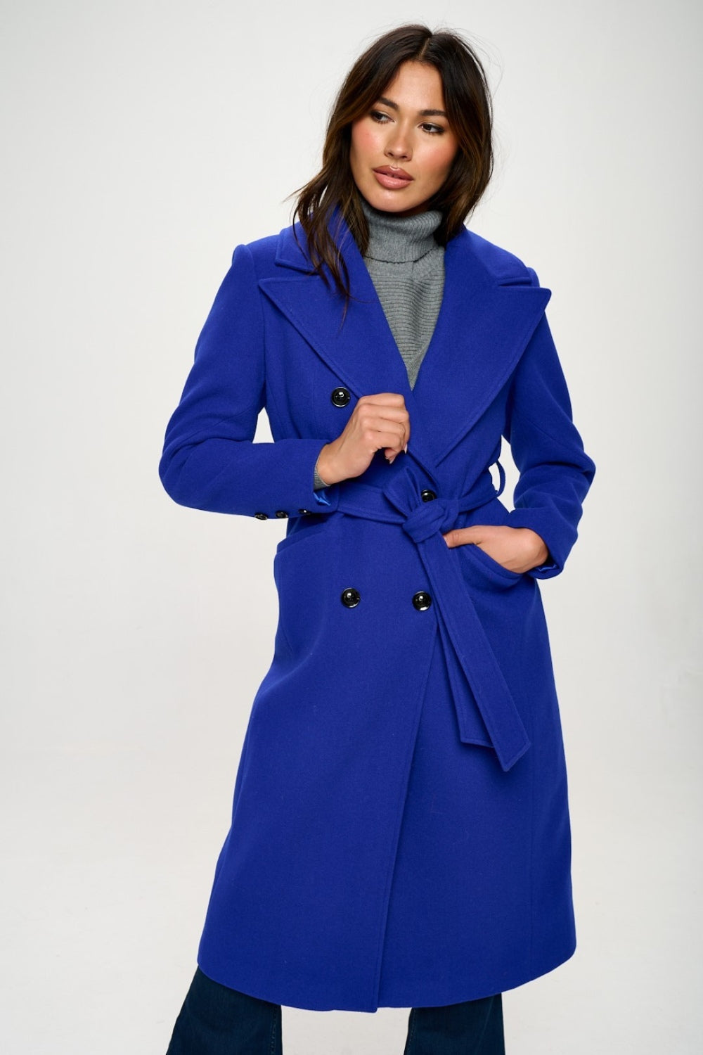 Woman wearing LA Double-Breasted Longline Belted Coat in Royal Blue, showing elegant style and flattering silhouette.