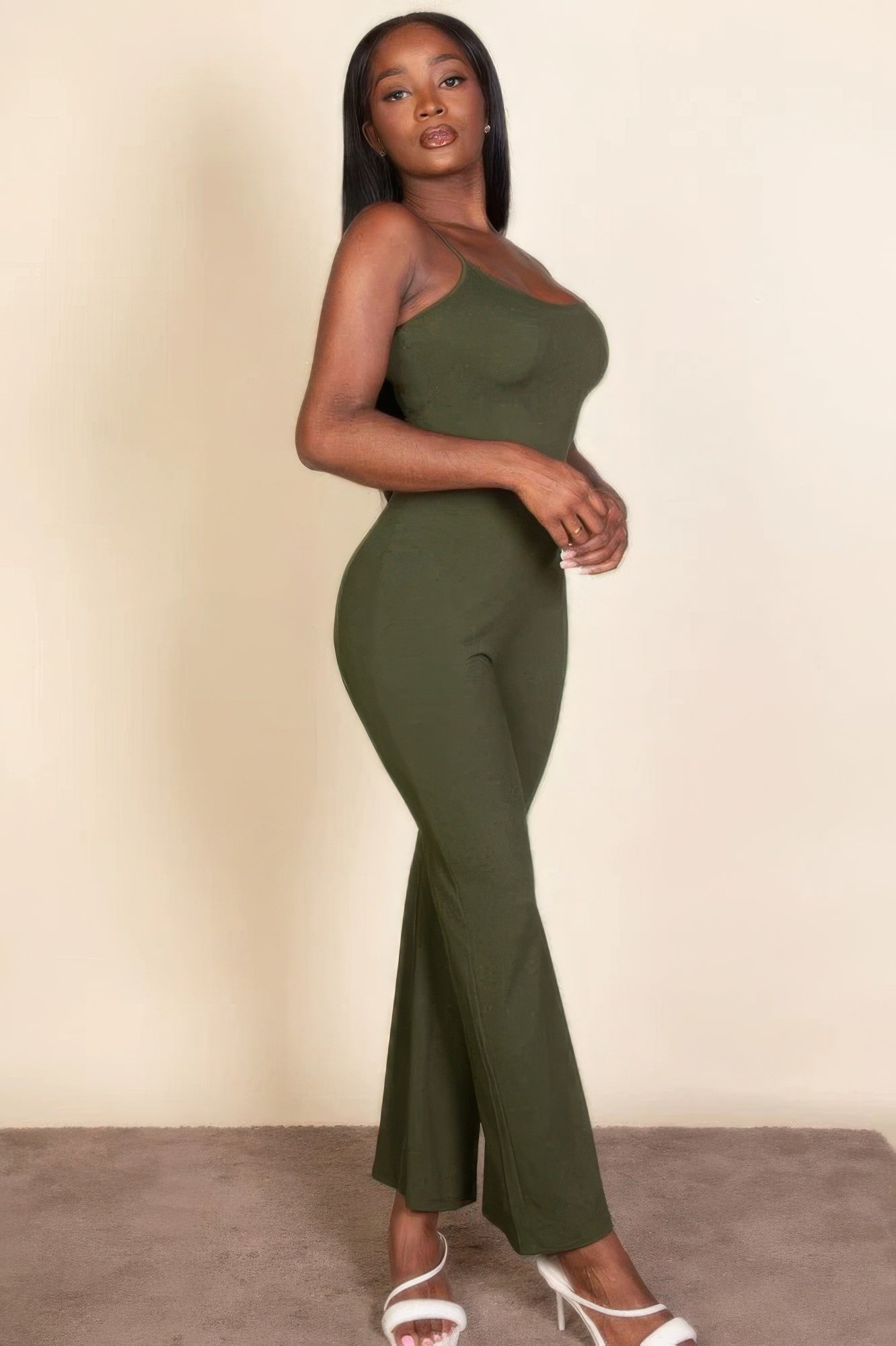 Olive green ribbed sleeveless wide-leg jumpsuit with fitted bodice and spaghetti straps, emphasizing an elegant and chic style.