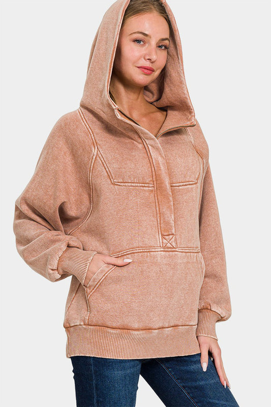 Woman wearing rust acid wash kangaroo hoodie with front pocket, 60% cotton 40% polyester, no stretch, casual style.