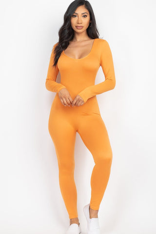 Woman wearing orange scoop neck long sleeve bodycon jumpsuit, high stretch jersey fabric