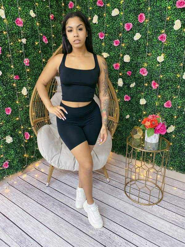 Woman wearing My Summer Tank Biker Short Set, seamless scoop neck crop top and biker shorts, posed against a floral wall.