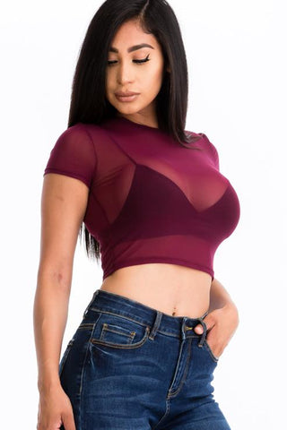Model wearing sexy mesh sheer crop top in burgundy, soft lightweight fabric, short sleeves, paired with jeans for a stylish look.