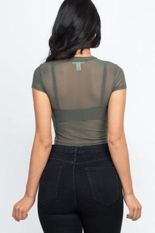 Back view of sexy mesh sheer short sleeve crop top with black jeans.
