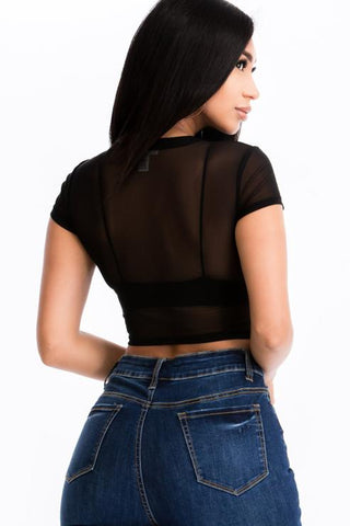 Back view of woman wearing black mesh sheer short sleeve crop top with blue jeans, highlighting lightweight design and trendy style.