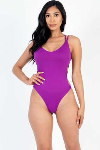 Model in a purple crisscross back V-neck bodysuit made of high stretch jersey, 92% polyester, 8% spandex. Perfect for a sexy, stylish look.