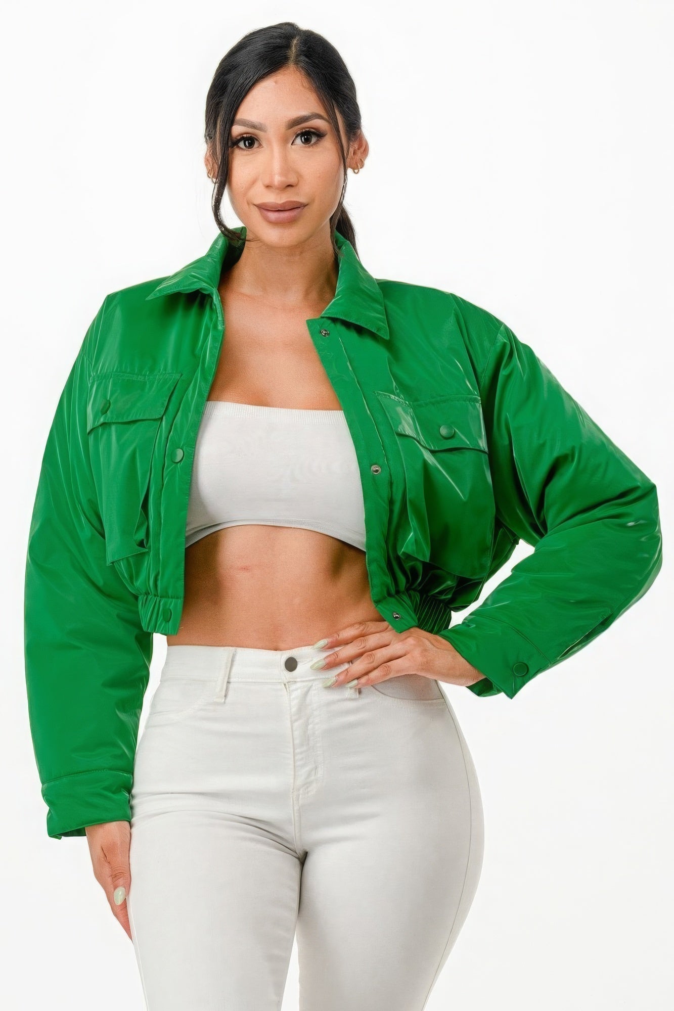 Woman wearing green cropped puffer bomber jacket with relaxed fit and snap button closure.