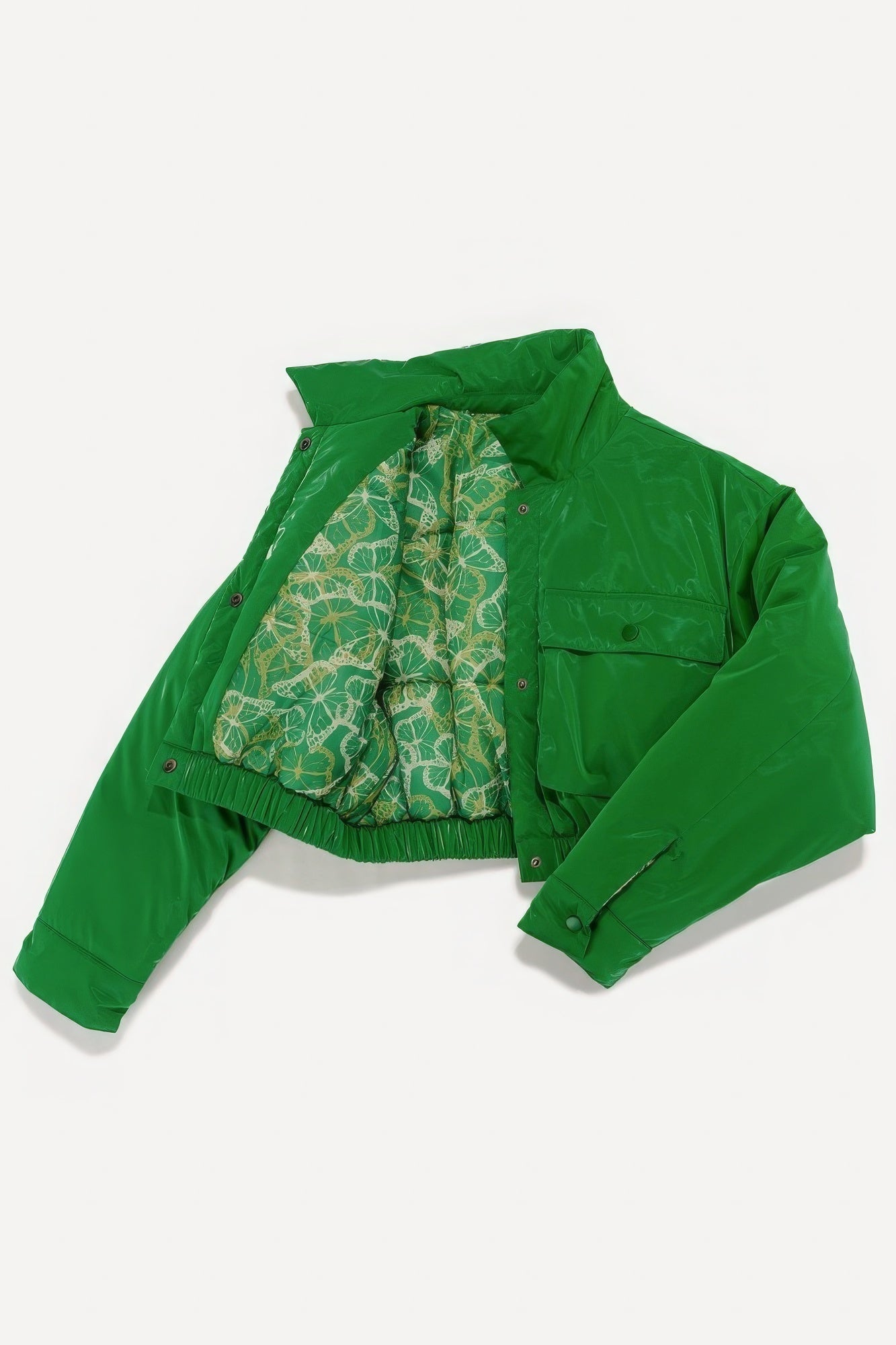 Green bomber jacket with patterned interior lining and snap button closure, showcasing a stylish and vibrant design.