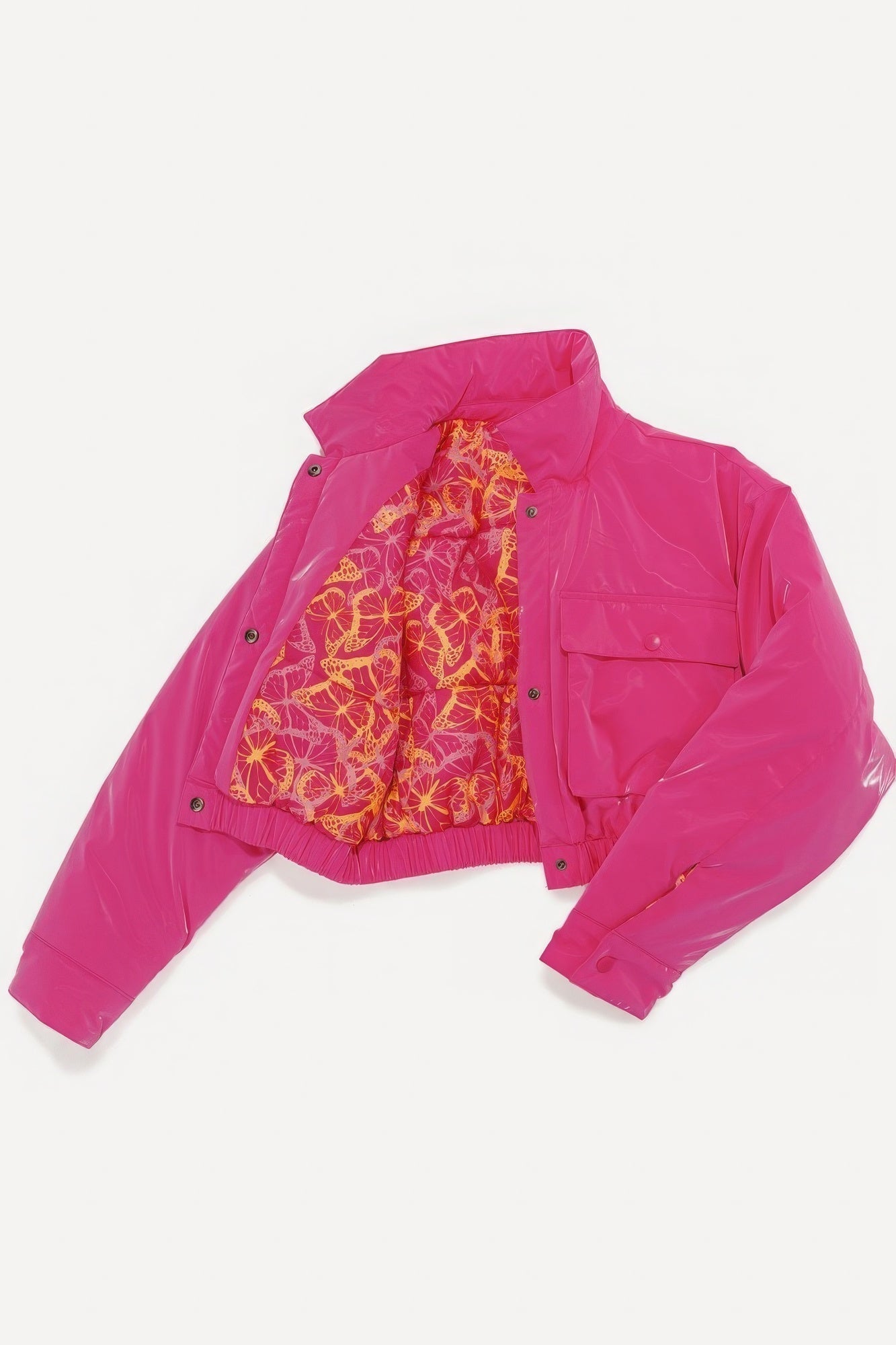 Vibrant pink shiny puffer bomber jacket with interior pocket and colorful lining, featuring snap button closure and relaxed fit.