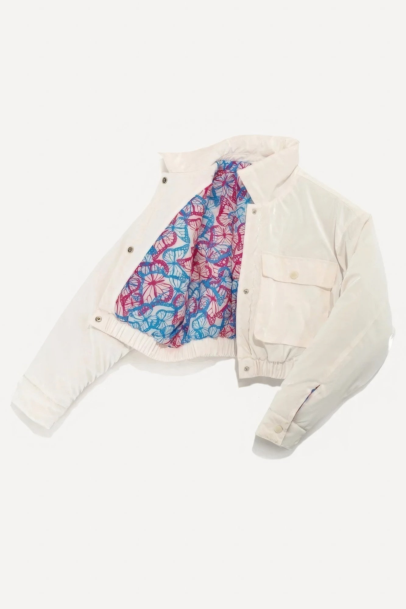 White puffer bomber jacket with colorful lining, front pockets, and snap button closure.