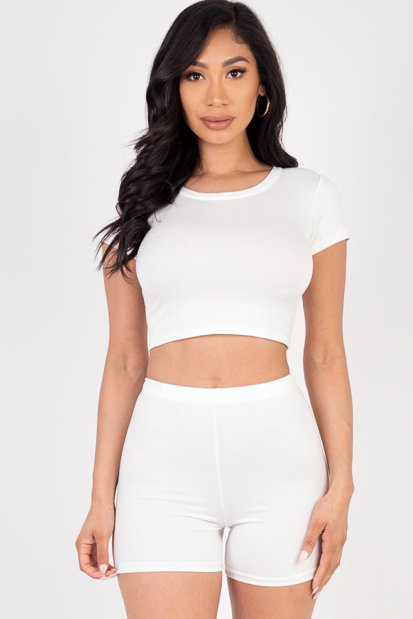 Model wearing a white short sleeve crop top and shorts set, soft and lightweight high stretch jersey, suitable for summer fashion.