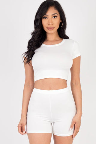 Model wearing a white short sleeve crop top and shorts set, soft and lightweight high stretch jersey, suitable for summer fashion.