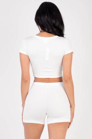 White short sleeve crop top and shorts set in soft, stretchy jersey fabric. Back view showing high-stretch material fit.