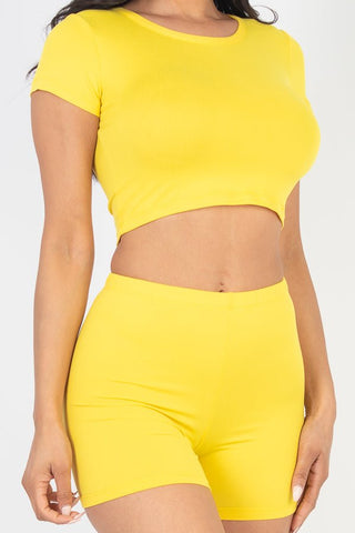 Yellow short sleeve crop top & shorts set made of soft, high-stretch jersey fabric, 92% polyester, 8% spandex, model wearing a small.