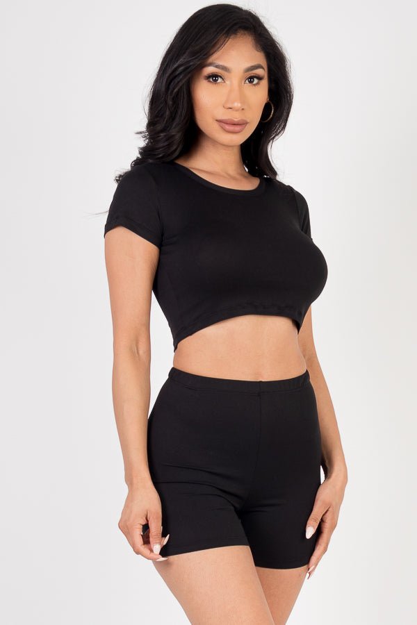 Model wearing a black short sleeve crop top and shorts set made of soft, lightweight, high-stretch jersey fabric; perfect for casual wear.