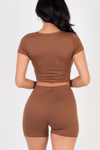 Model wearing brown short sleeve crop top and shorts set, soft high stretch jersey, 92% polyester, 8% spandex, back view.