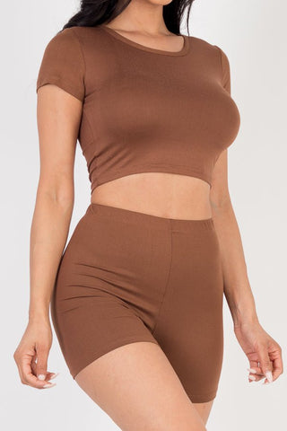Woman wearing a brown short sleeve crop top and shorts set, made of soft, high stretch jersey fabric, ideal for casual wear.