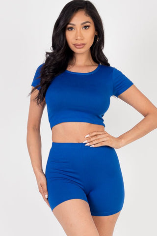 Model wearing a blue short sleeve crop top and shorts set made of lightweight, stretchy jersey fabric with 92% polyester and 8% spandex.