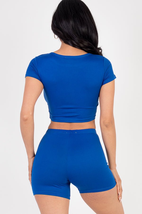 Model wearing a bright blue short sleeve crop top and shorts set, showcasing soft, lightweight jersey fabric with high stretch.