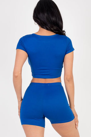 Model wearing a bright blue short sleeve crop top and shorts set, showcasing soft, lightweight jersey fabric with high stretch.