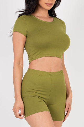 Model wearing olive green short sleeve crop top and shorts set, soft lightweight high stretch jersey, made of 92% polyester, 8% spandex.