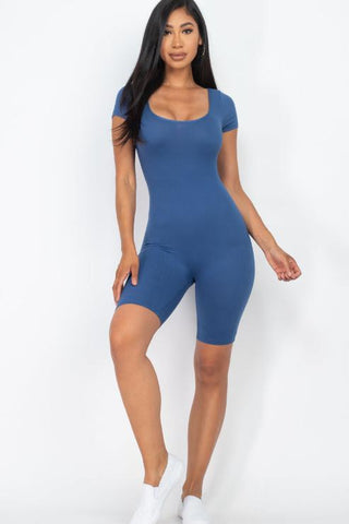 Woman wearing a blue short sleeve scoop neck bodycon romper, highlighting tight yet comfortable fit; fabric is lightweight and stretchy.