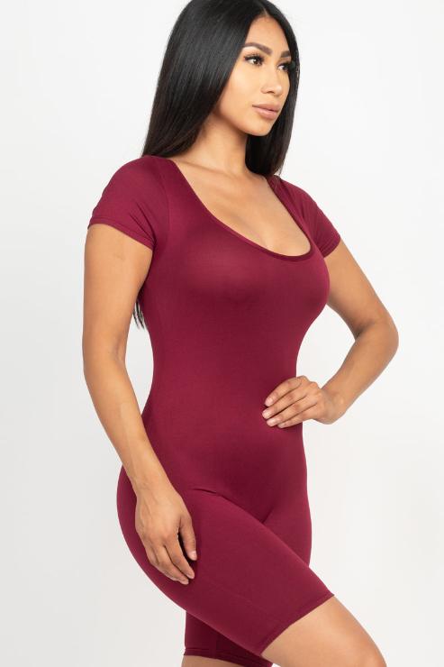 Woman wearing a maroon short sleeve scoop neck bodycon romper, showcasing a tight yet comfortable fit made from 92% polyester and 8% spandex.