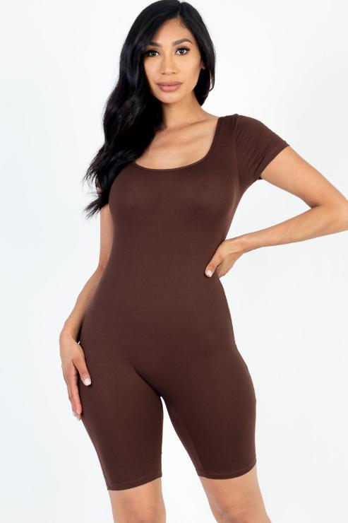 Model wearing brown short sleeve scoop neck bodycon romper, stretchy fit, made of 92% polyester and 8% spandex, shown in a small size.