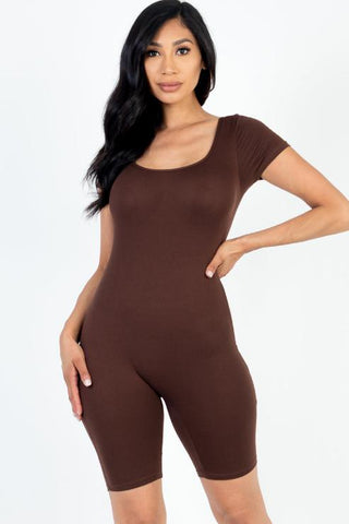 Model wearing brown short sleeve scoop neck bodycon romper, stretchy fit, made of 92% polyester and 8% spandex, shown in a small size.