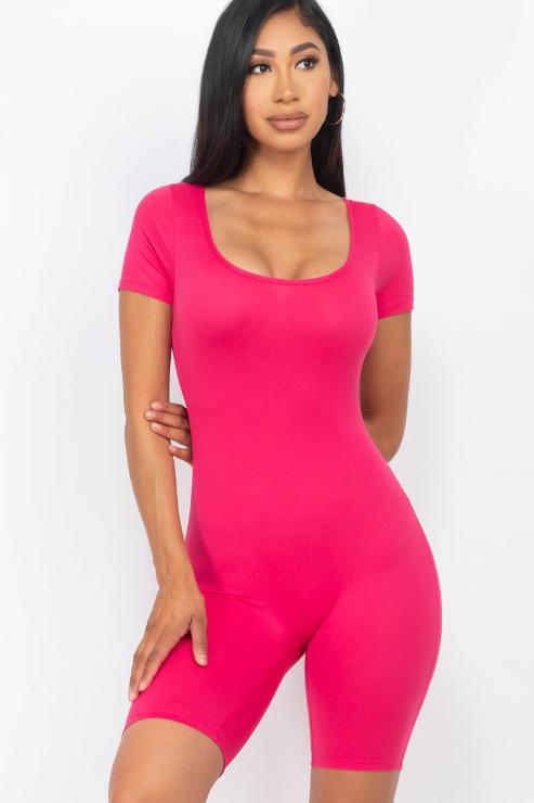 Model wearing pink short sleeve scoop neck bodycon romper, showcasing a comfortable and stretchy fit.