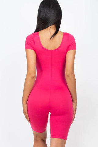 Back view of a bright pink short sleeve scoop neck bodycon romper, highlighting its snug fit and stretchy, lightweight fabric.