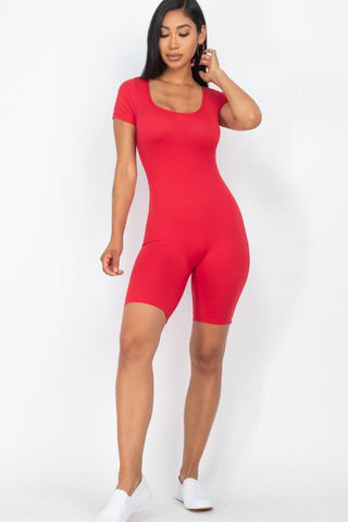 Woman wearing red short sleeve scoop neck bodycon romper, showcasing a form-fitting, stretchy design perfect for a stylish look.